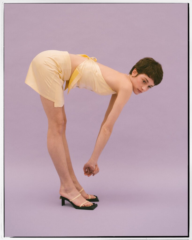Mujer flexionando la espalda hacia delante en una foto de estudio